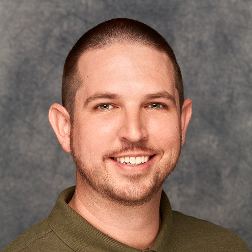 A man wearing a green polo shirt.